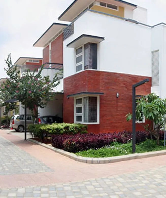 Vaishnavi Commune, Sarjapur Road A red-brick villa at Vaishnavi Commune, shown for representation
